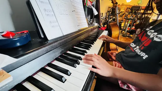 Student at the piano at Stars Music School, Inwood WV
