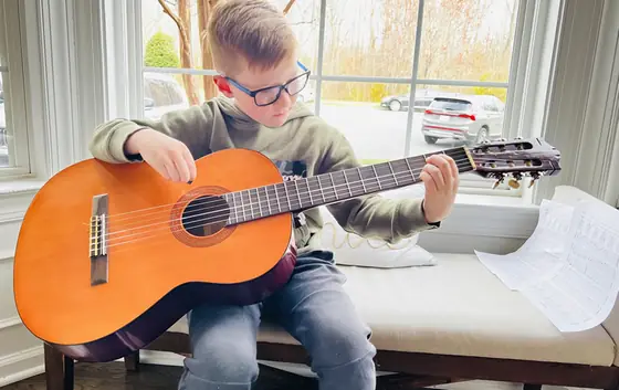 Student at the guitar at Stars Music School, Inwood WV